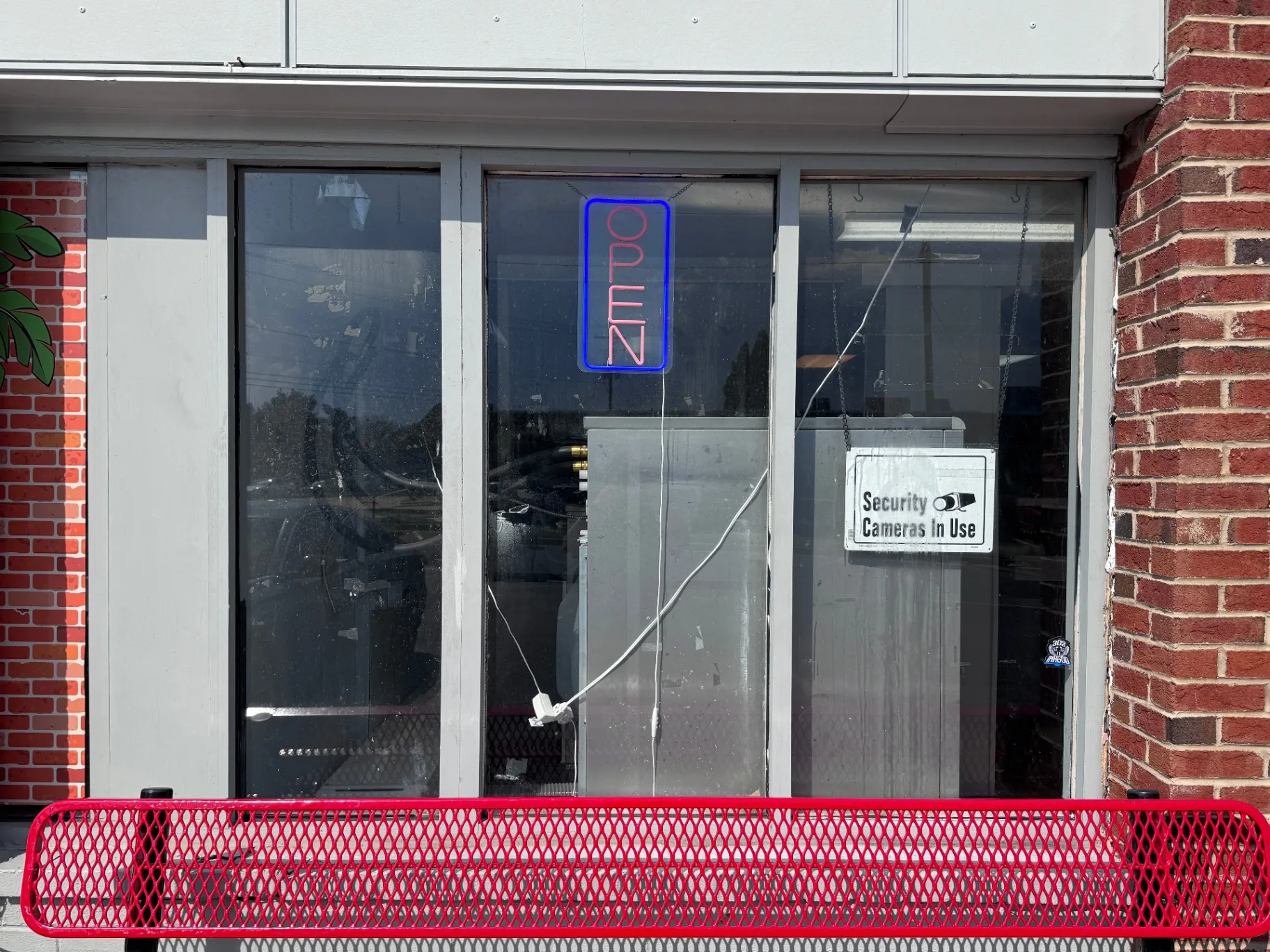 Before photo of laundromat window before vinyl graphics installation in Delaware